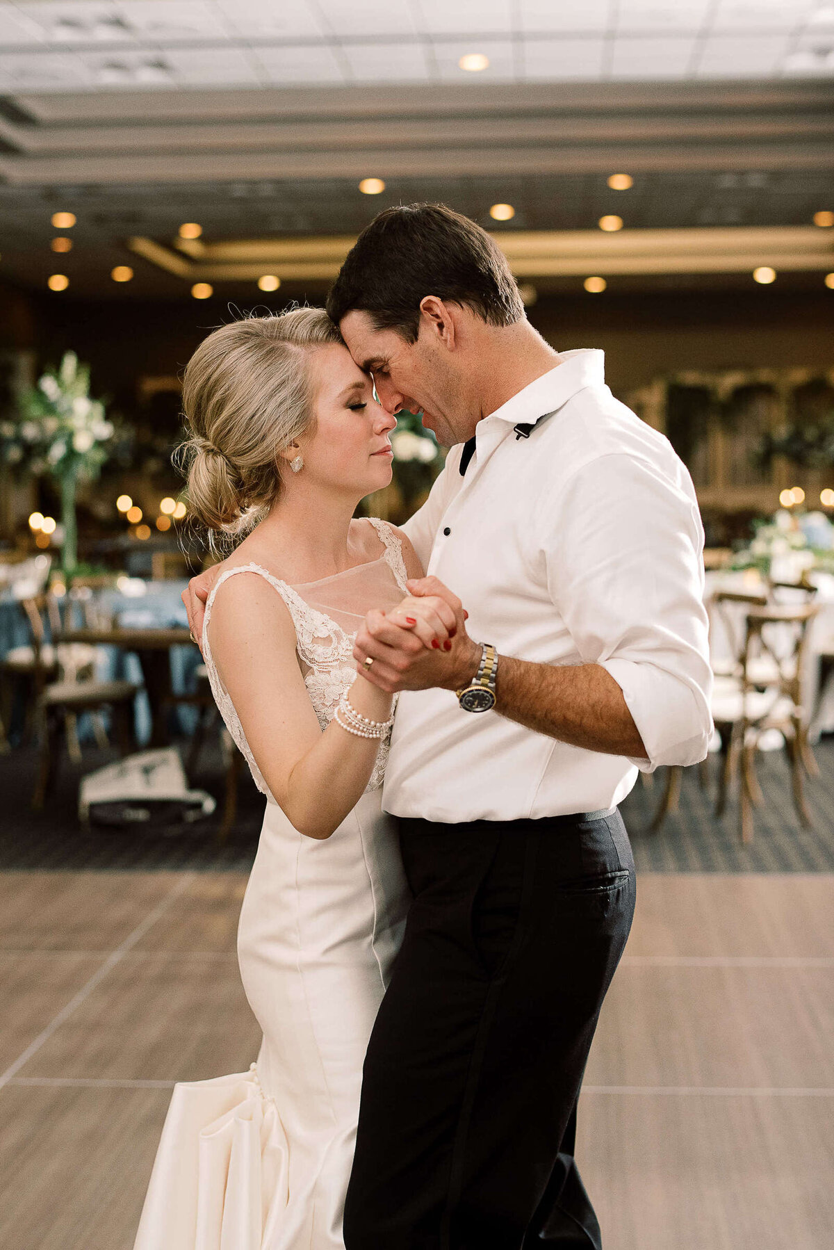 Bride and groom embrace as they slow dance at Texas hill country wedding