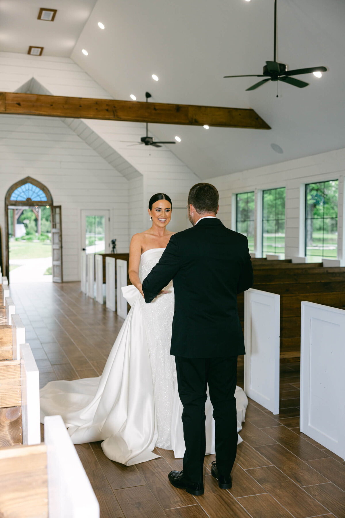 A candid wedding day photo of the bride and groom during their first look
