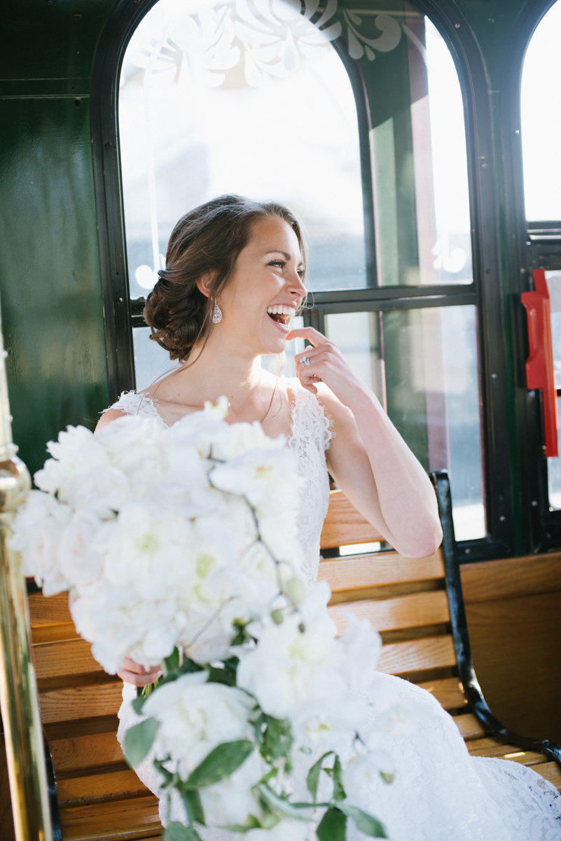 bride laughing on the trolley