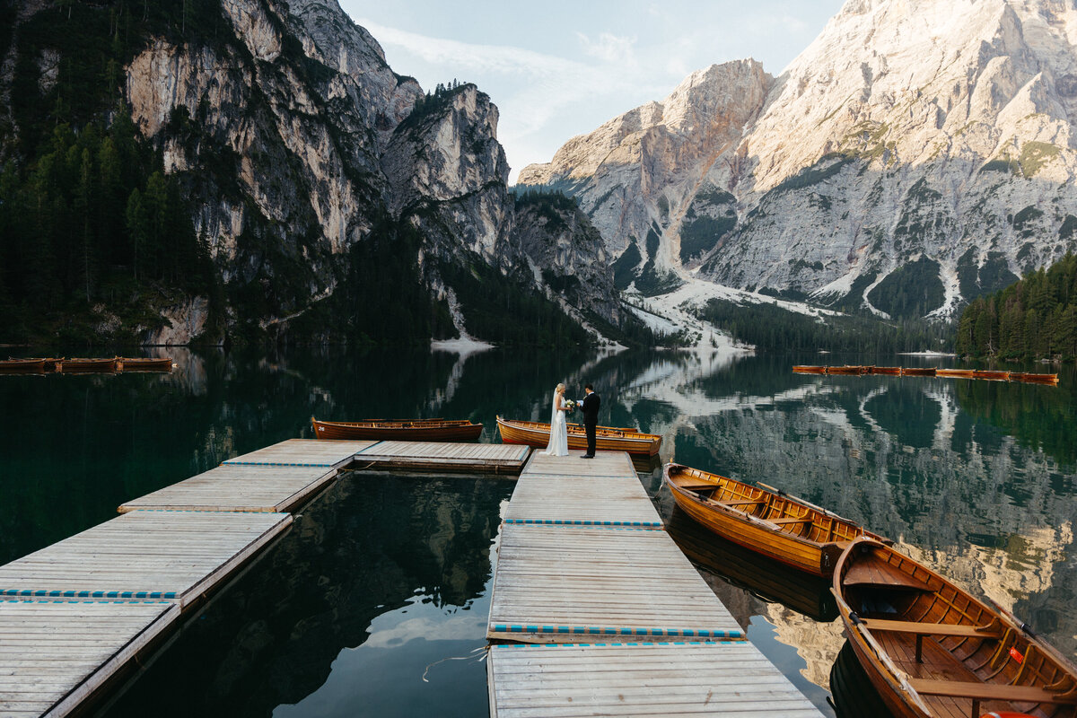 Bride and groom exchanging vows on dock at Lago di Braies