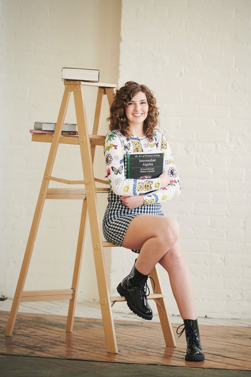 High School Senior Picture Photographer Captures Student with Books on Ladder-12