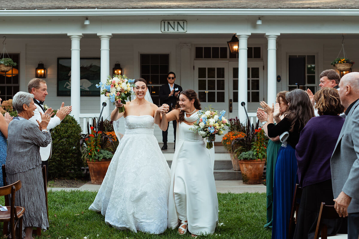 Brides celebrating walking down aisle