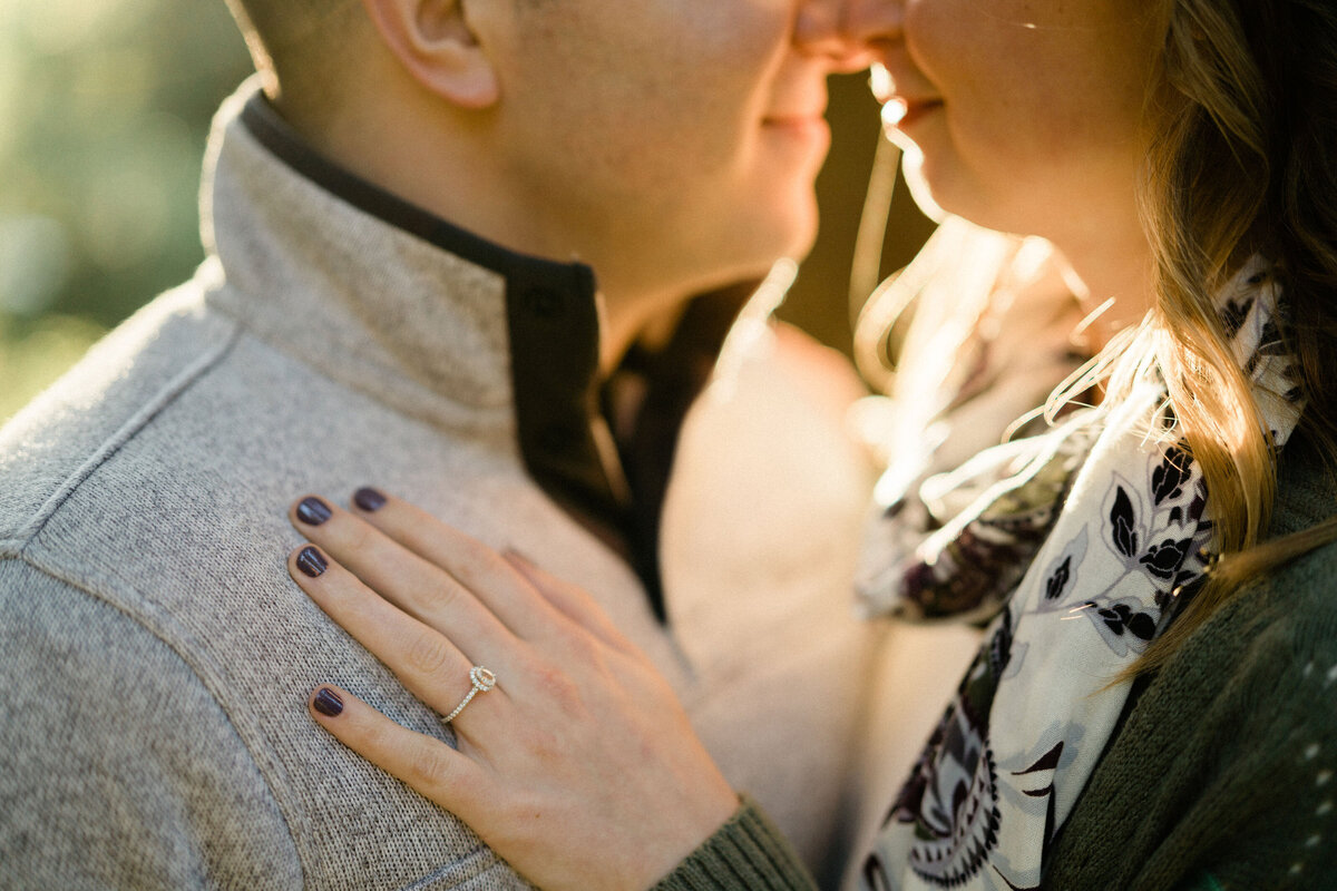 seattle engagement photographer takes picture of couple and engagement ring at university of washington arboretum