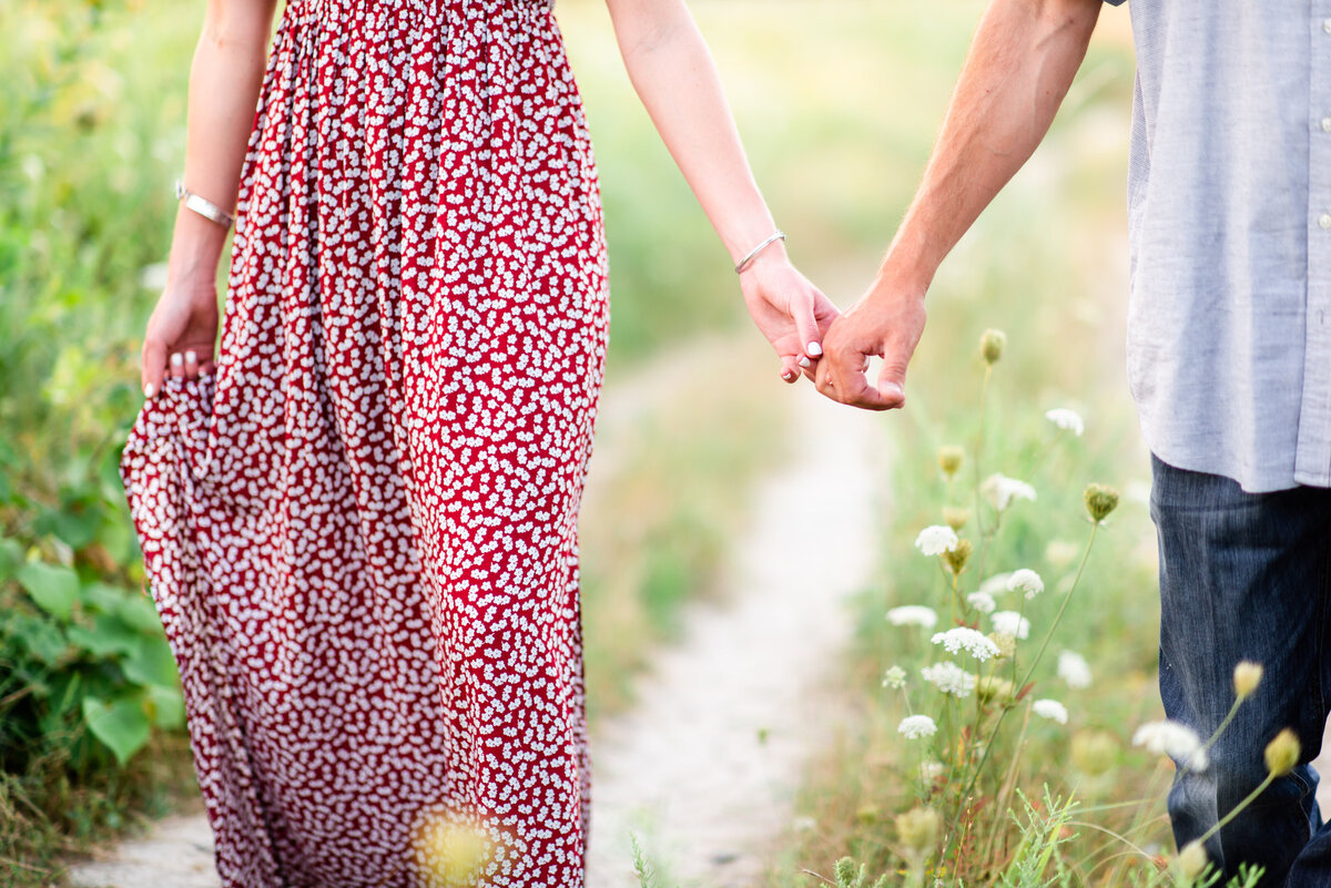 Happy couple holds hands, dreamy picture at white rock lake.