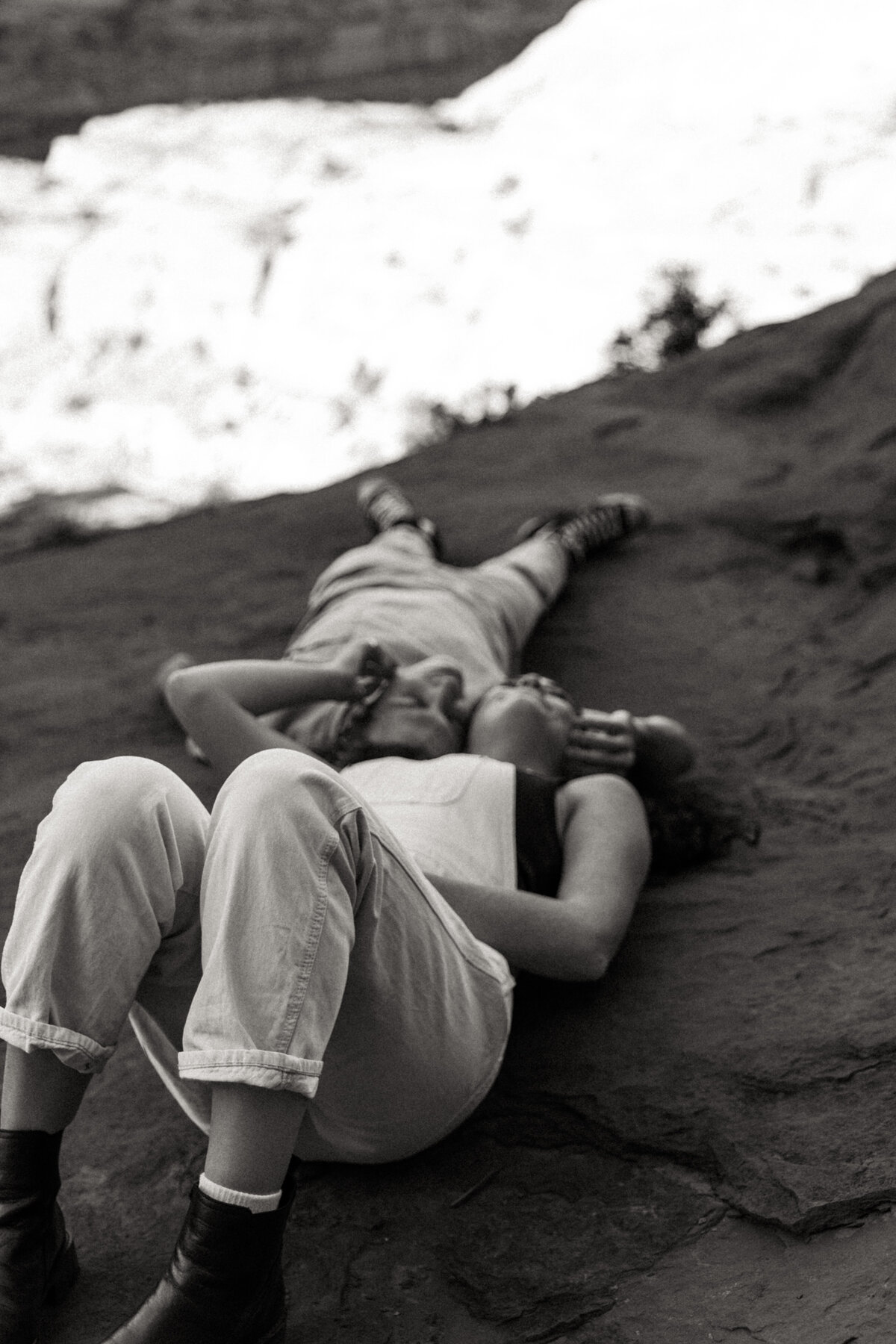 Desert Engagement Photo where the couple is laying down togther on the ground 