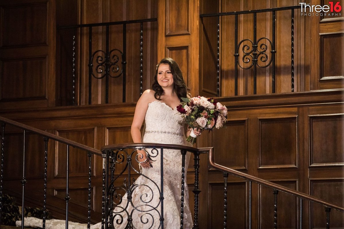 Bride poses as she enters from the staircase