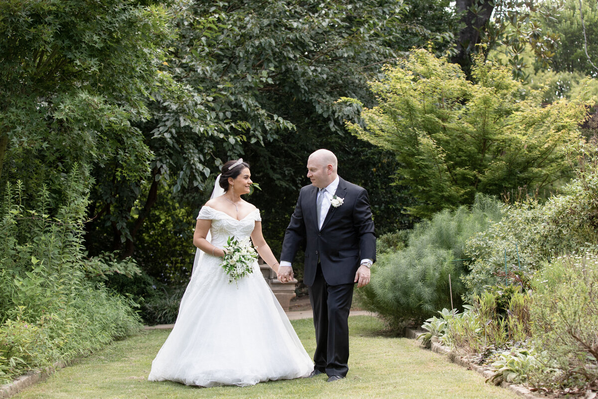 bride-groom-romantic-garden-walk-holding-hands