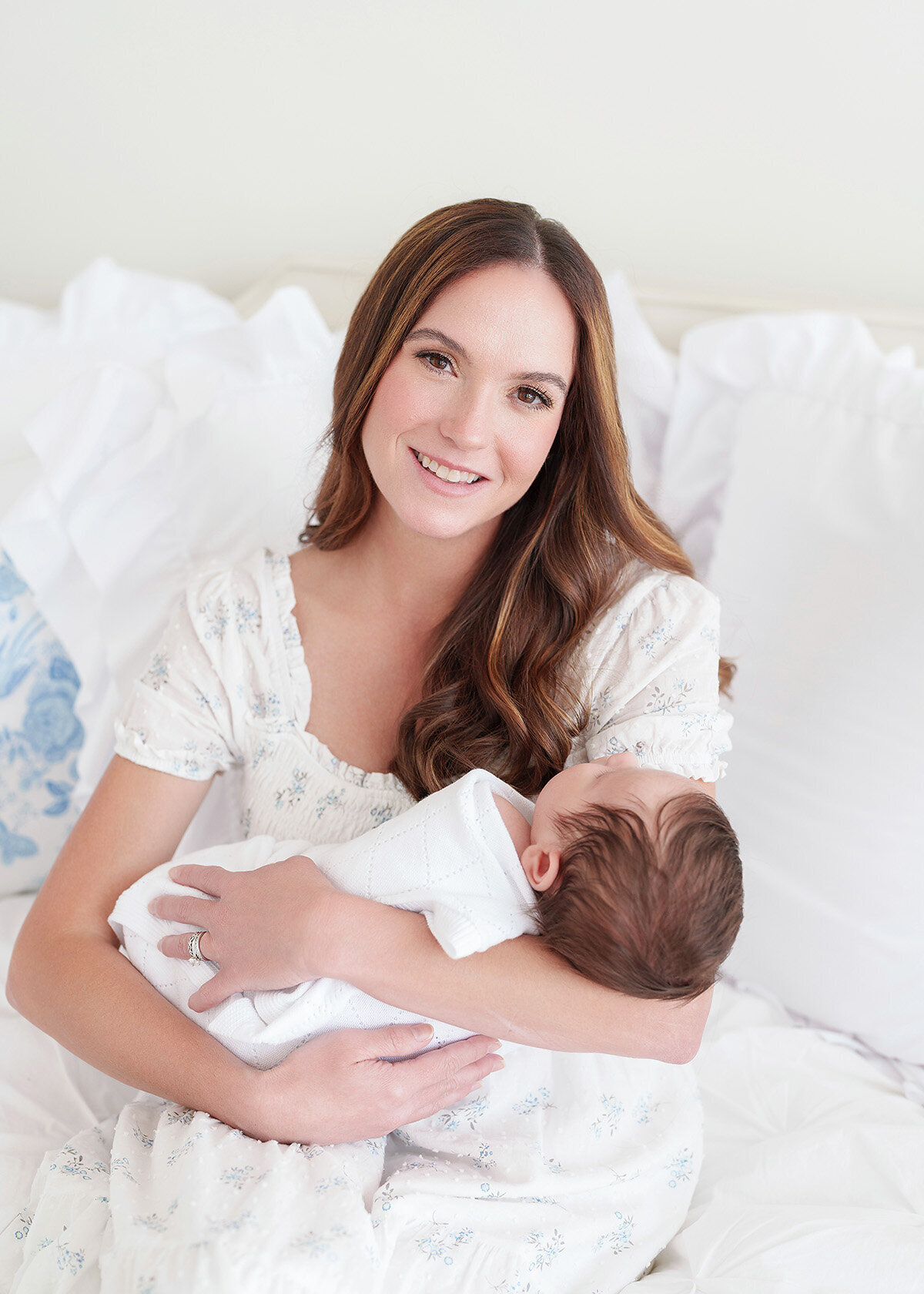 newborn baby with his mother photographed on a grandmillenial style daybed and clothing