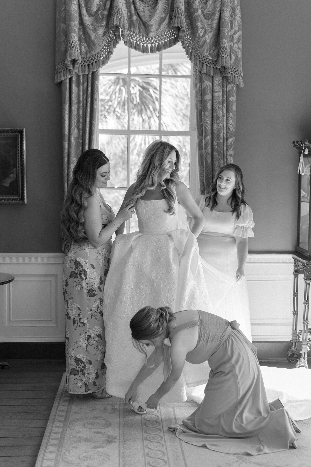 Bride and bridesmaids moments before wedding ceremony. William Aiken House Fall wedding. Black and white wedding photos. Kailee DiMeglio Photography.