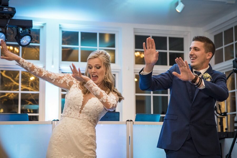 A bride and groom strike fun dance poses at their wedding reception at The Manor House in Littleton, Colorado.