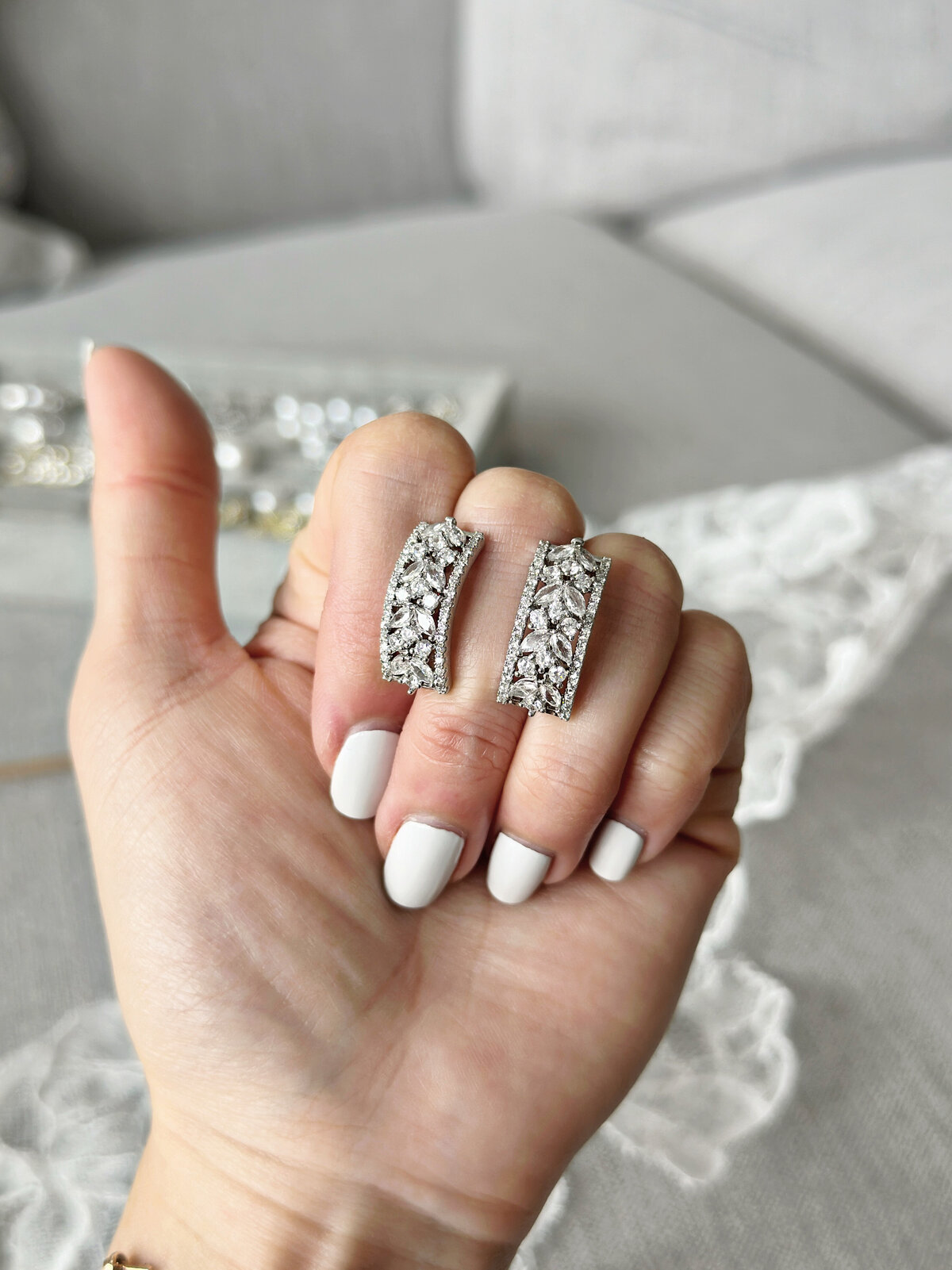 Romantic crystal and pearl jewelry complementing modern bridal gowns
