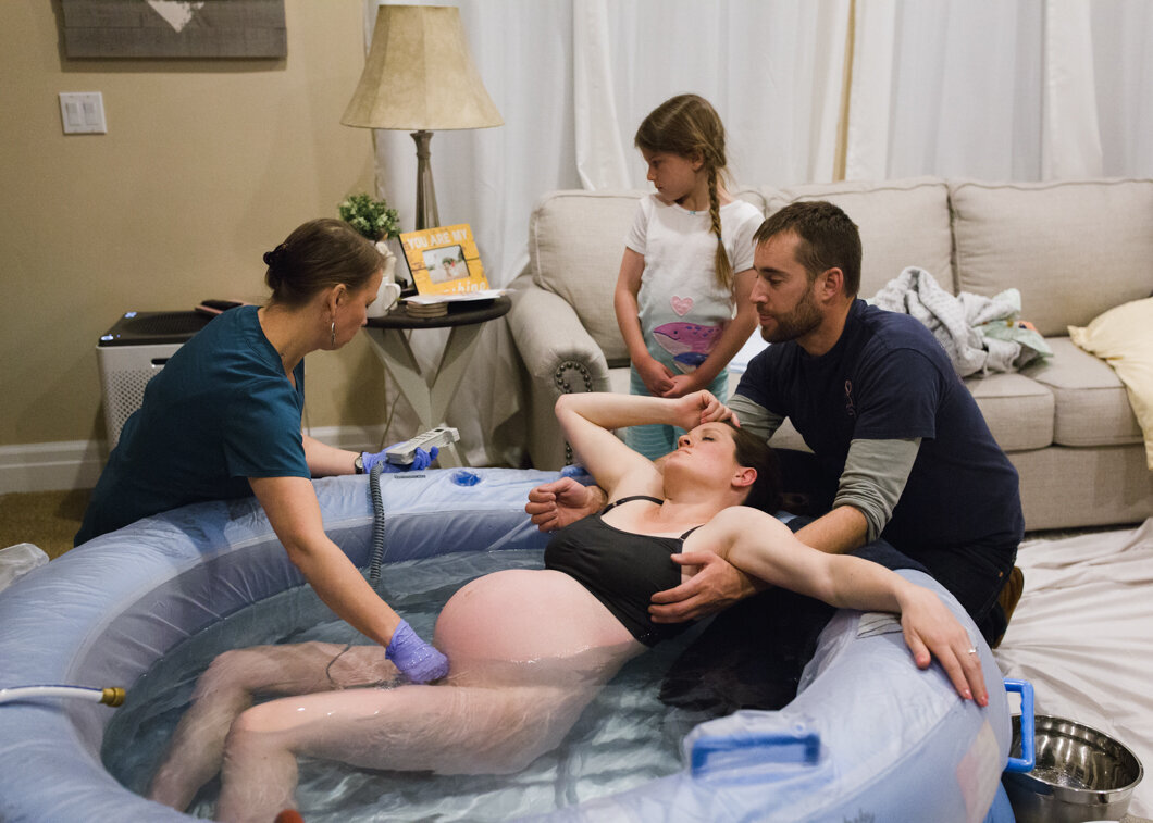 Checking the baby's heart rate during labor at home. Diane Owen Photography.