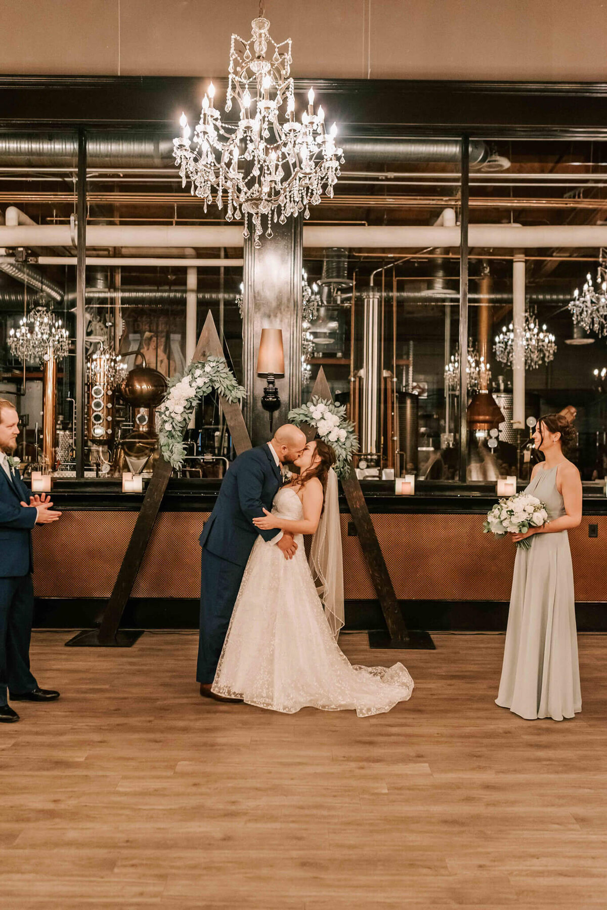 Bride and groom share first kiss at ceremony. 