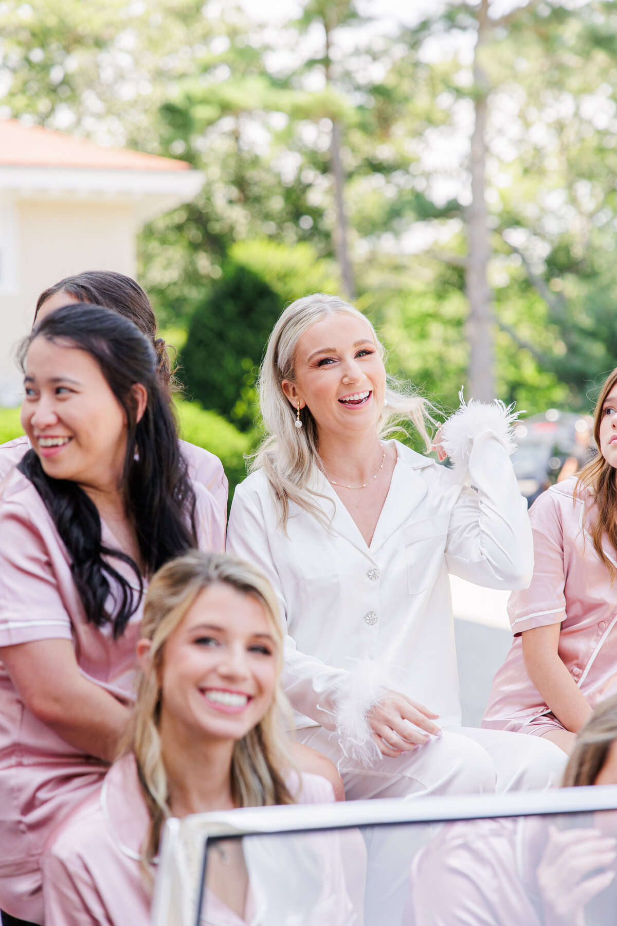 Bride and her bridesmaids laughing representing joyful Boston wedding photography