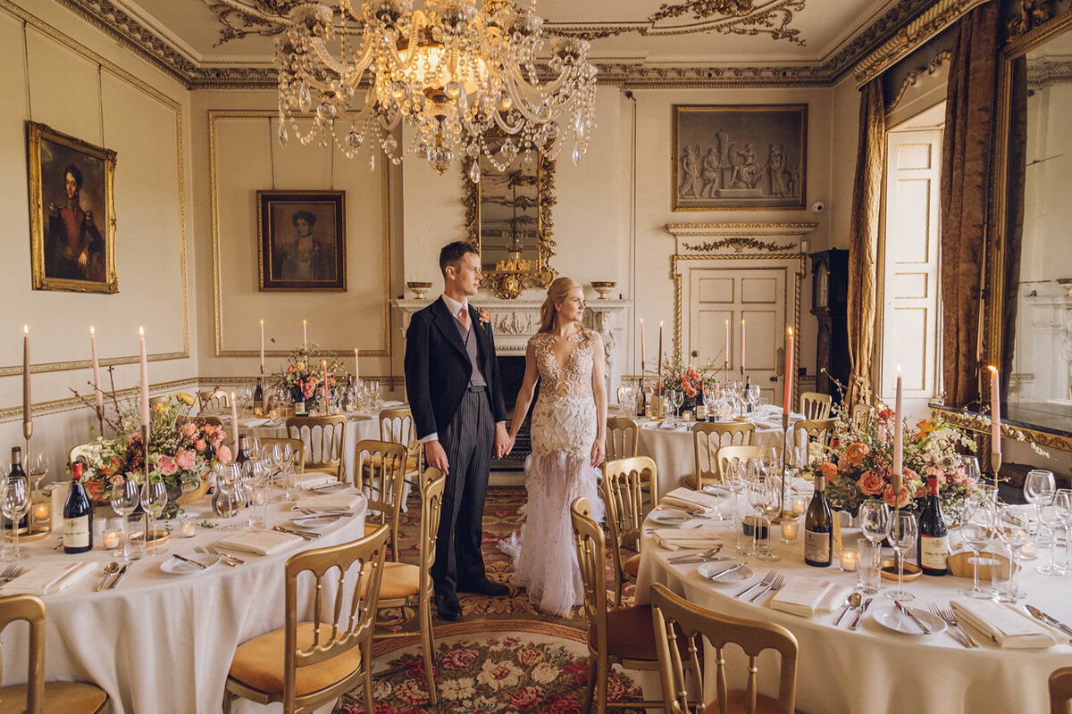 Bride and Groom standing in grand reception dinner room