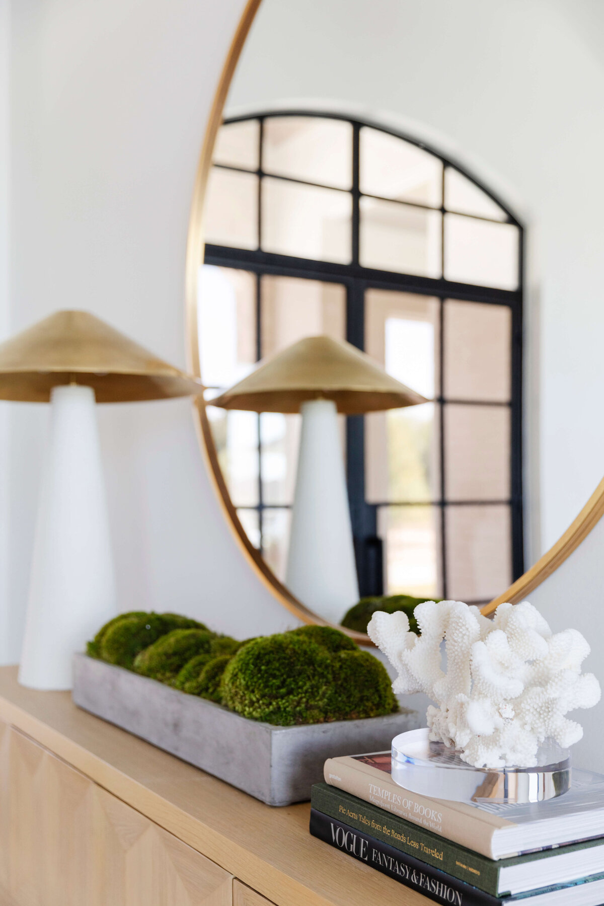 oyster creek studios hughes gold mirror with books and stone vase