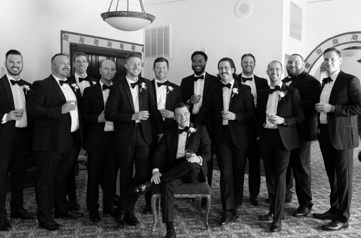 Groomsmen smiling and surrounding groom to show wedding photography chicago by Allison Francois Photography