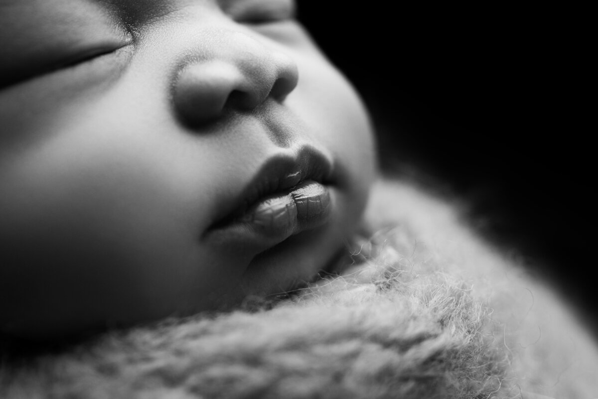 Fine art newborn baby photoshoot with Philadelphia's best newborn photographer Katie Marshall. Black and white close-up detail image of baby's nose an lips.