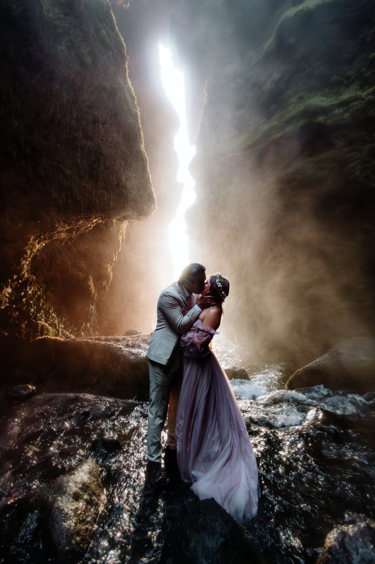 engaged couple is posing in front of an erupting volcano in Iceland