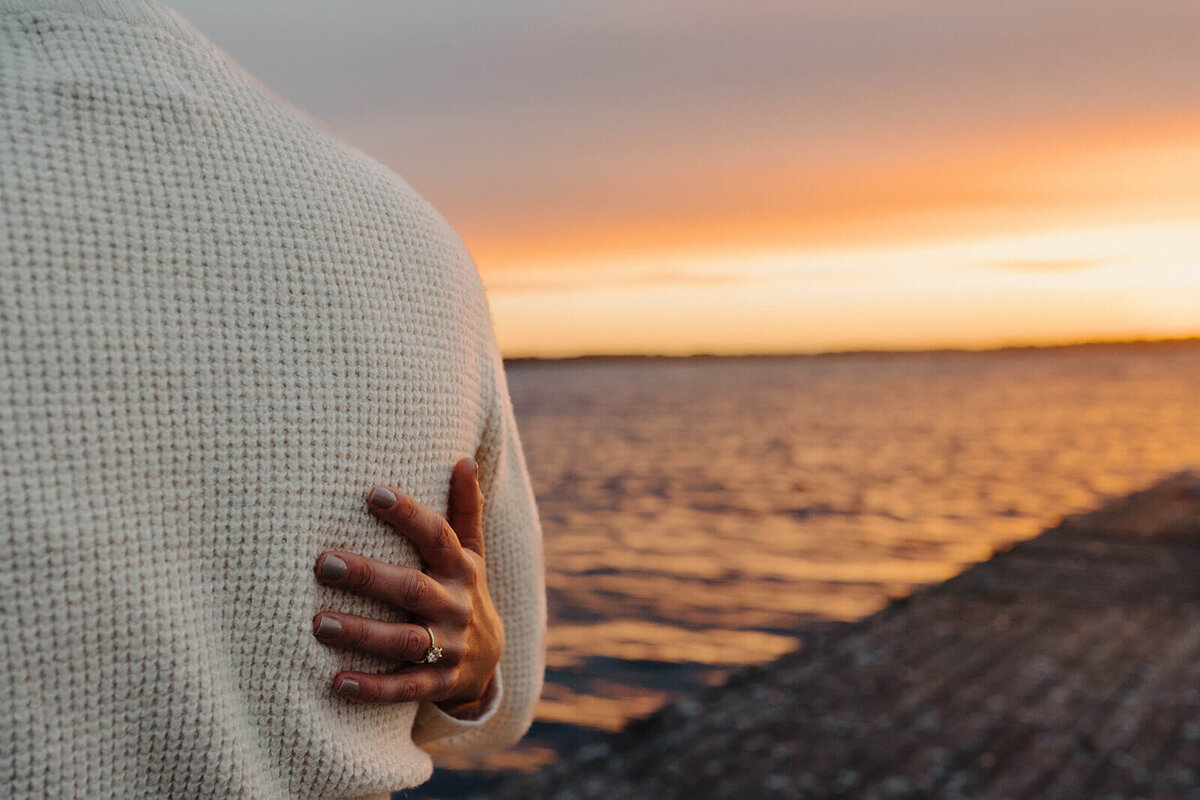 Womans hand on mans back at Finger Lakes engagement session