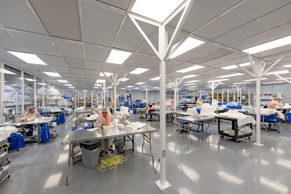 Clean industrial workspace with many working stations throughout the large space