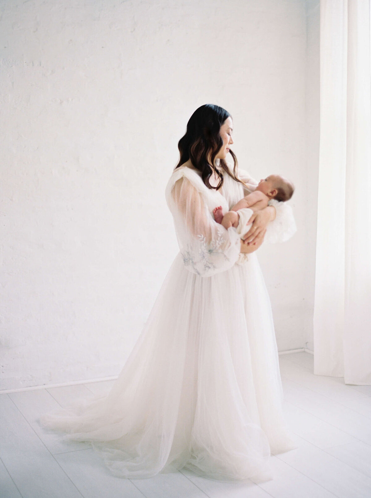 Mother holding baby, candid newborn photography San Francisco Bay Area.