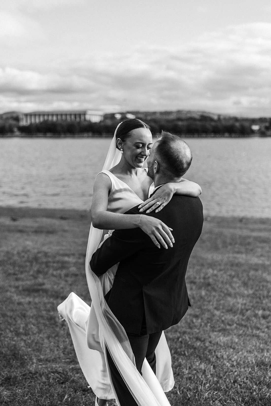 Black and white image of bride and groom overlooking Lake Burley Griffin in Canberra