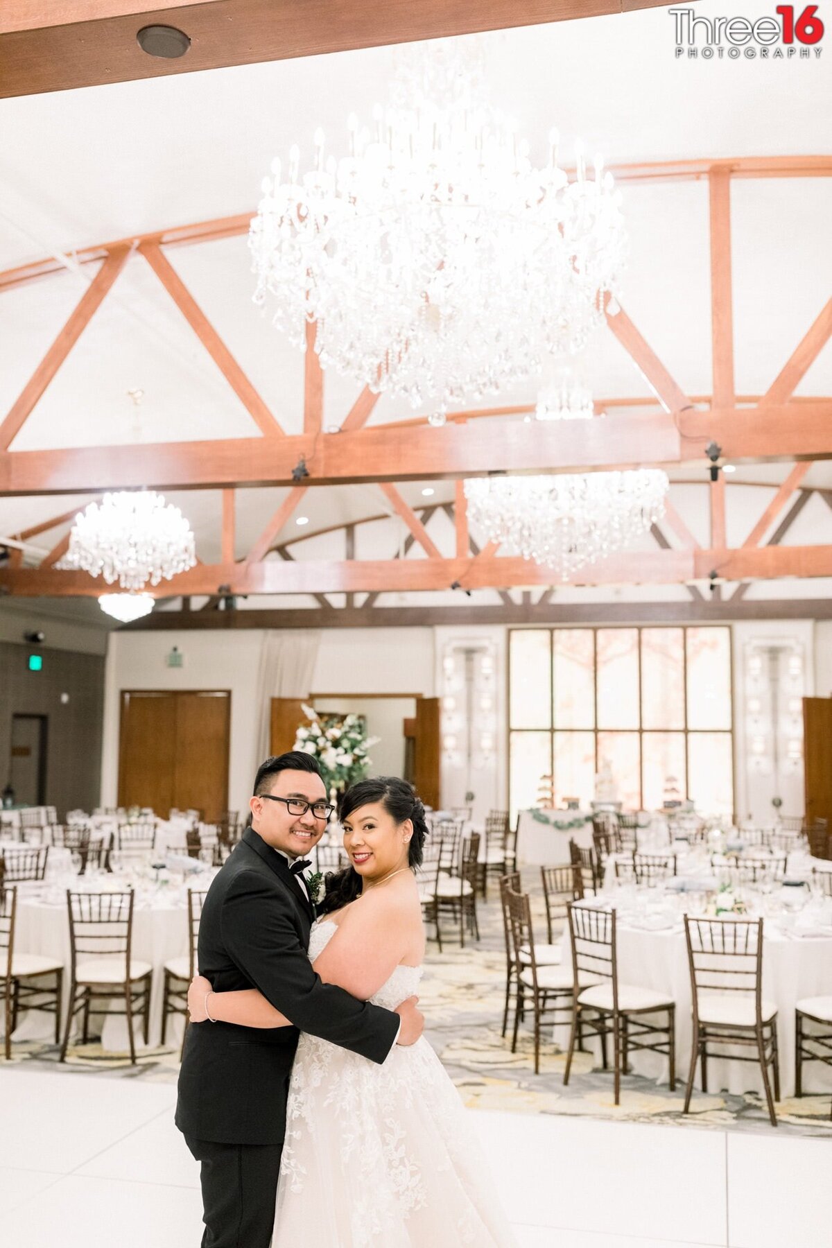 Bride and Groom hug each other in the reception area before guests arrive inside