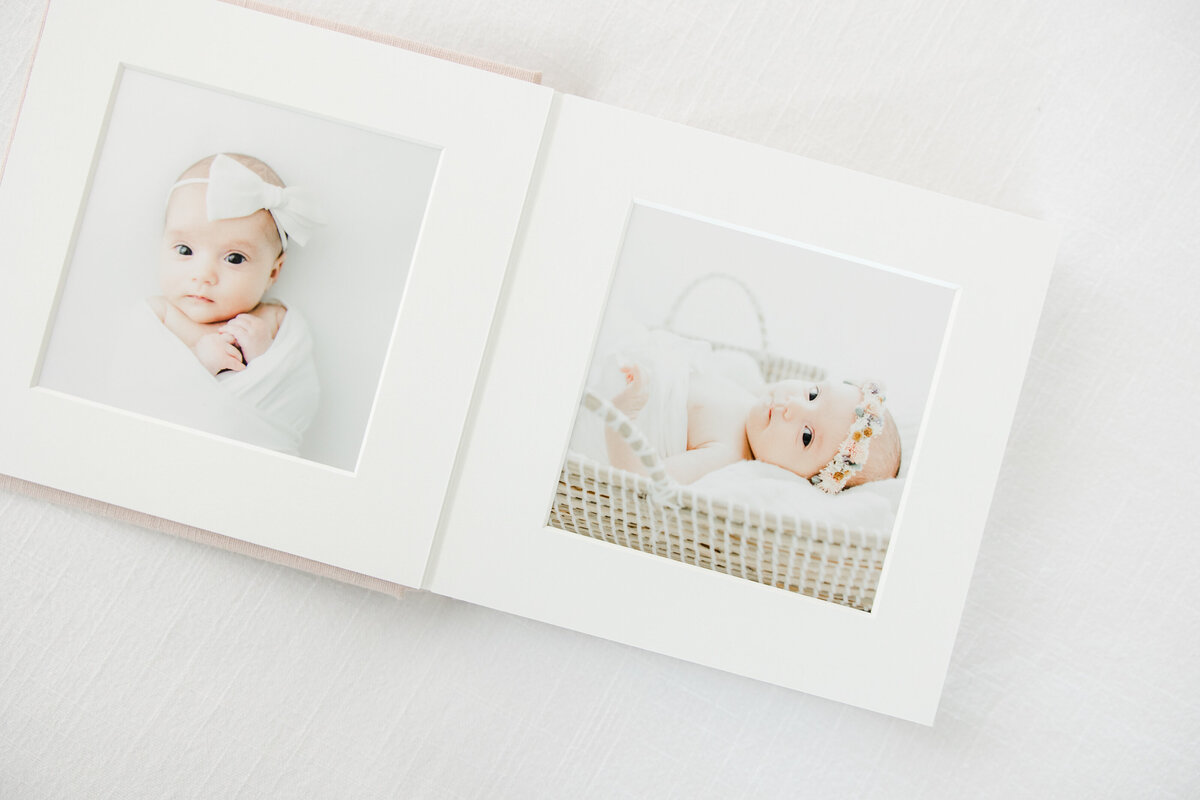 Family photo album opened to a spread of a newborn baby girl