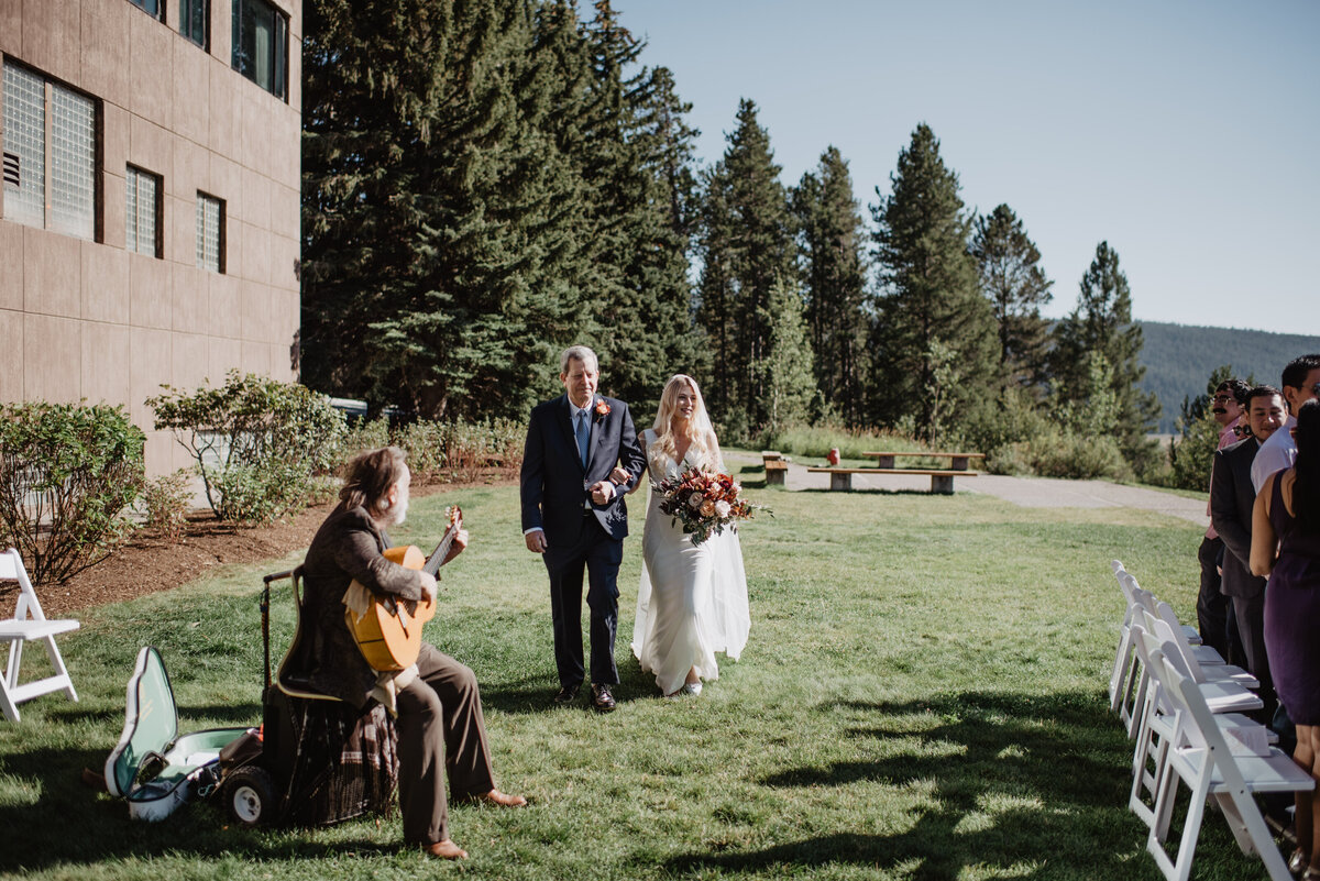 Photographers Jackson Hole capture bride walking down aisle