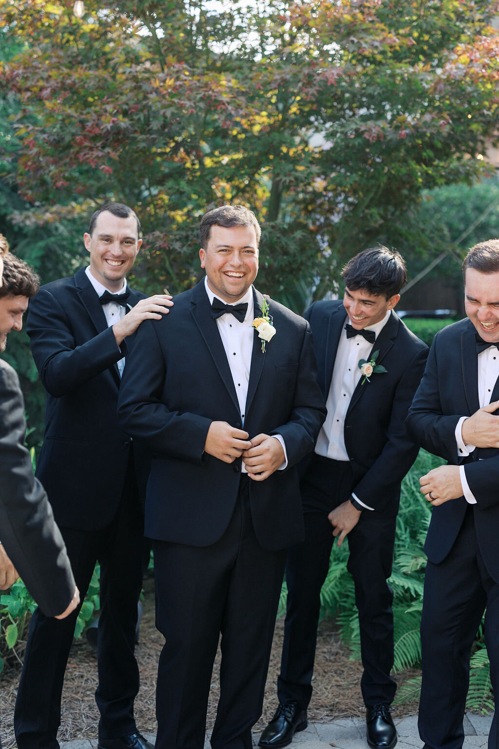 Groomsmen laugh and smile at 255 Milledge