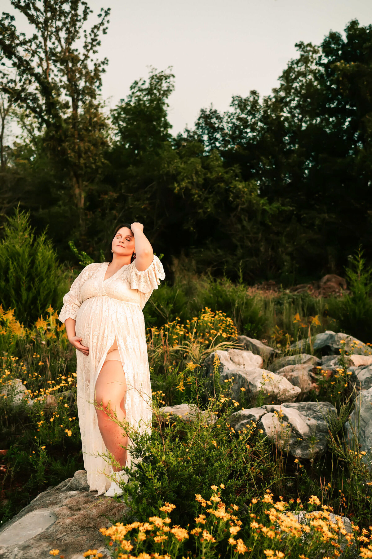 maternity photo in Branson MO of pregnant mom in yellow flowers
