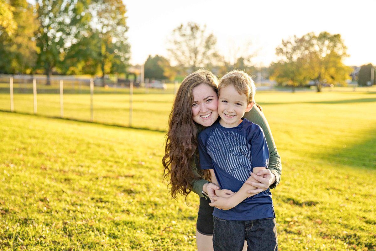 Mom wrapping arms around son