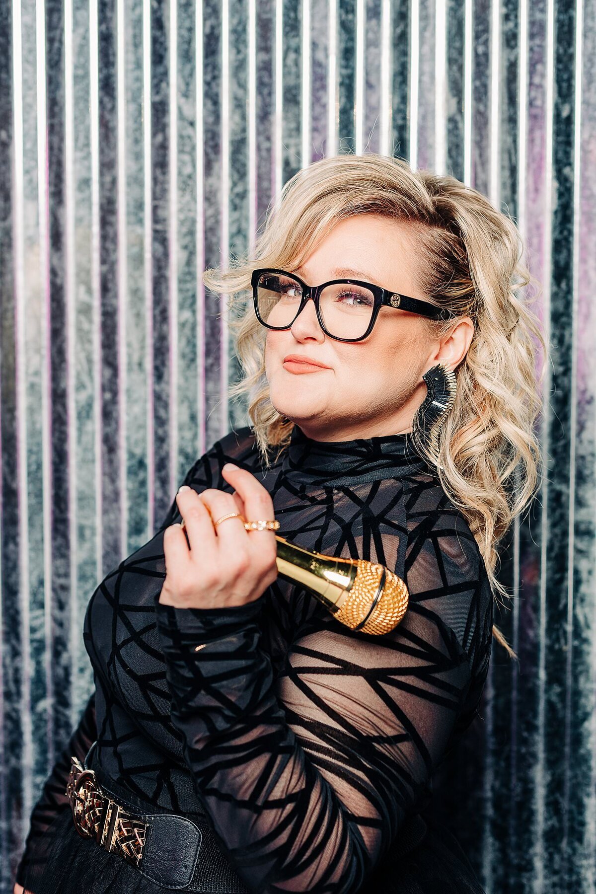 Branding photoshoot for female dj holding a golden microphone