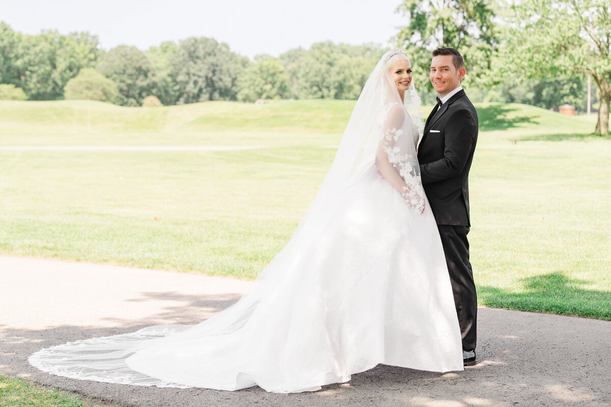 wedding couple poses for a photo on the golf course of The Grand Resort in warren ohio