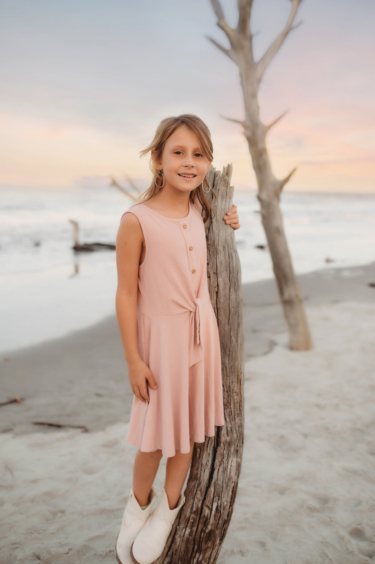 Little girls smiles at the camera during Family Photos Folly Beach.