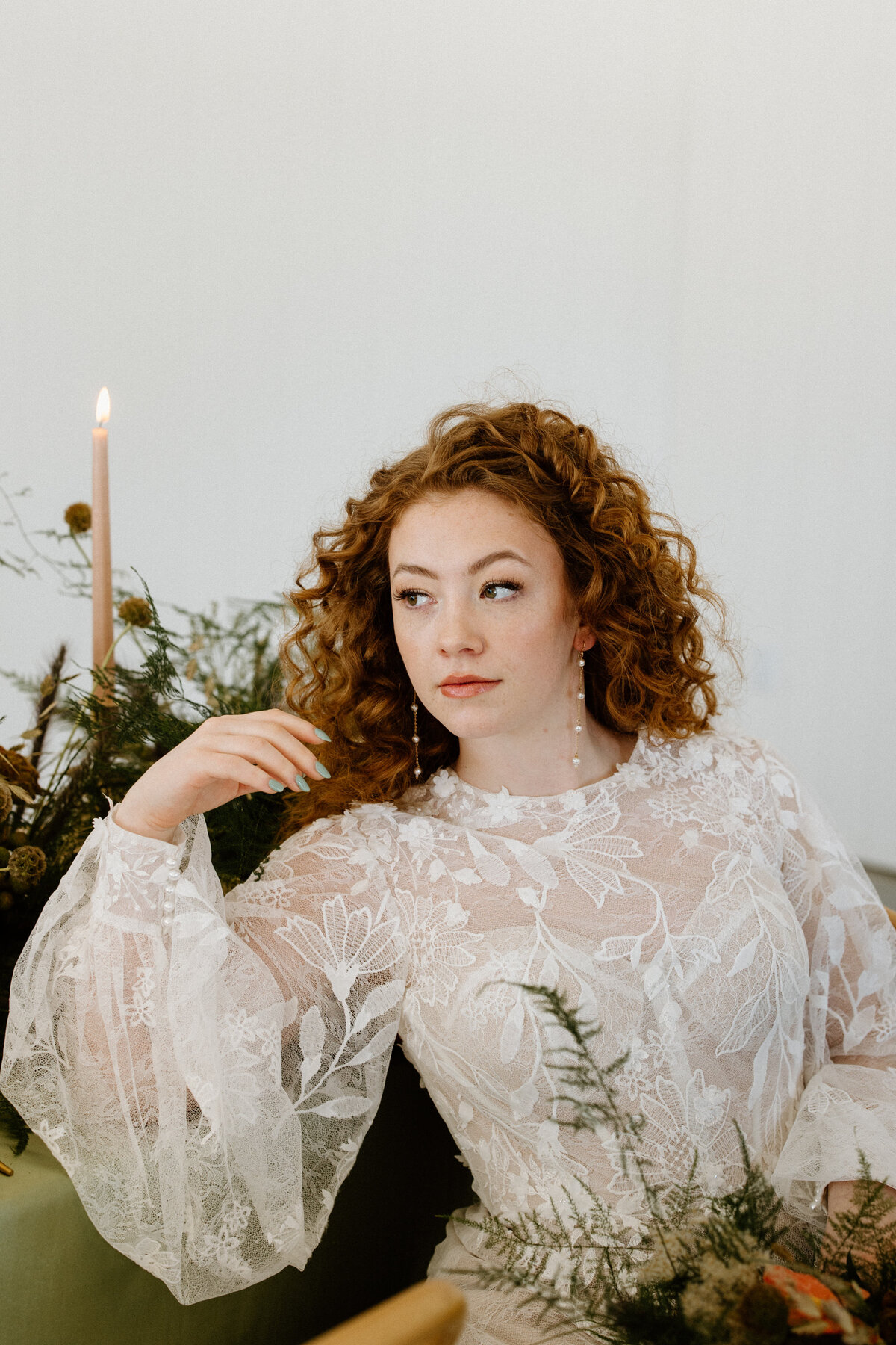 A solo portrait of a bride in her wedding dress, looking at the side