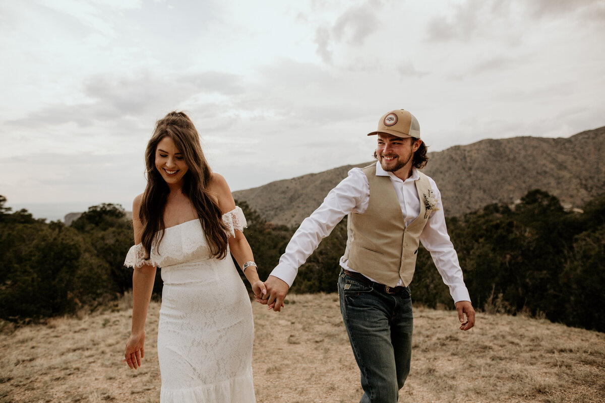 newlyweds walking through the foothills in Albuquerque