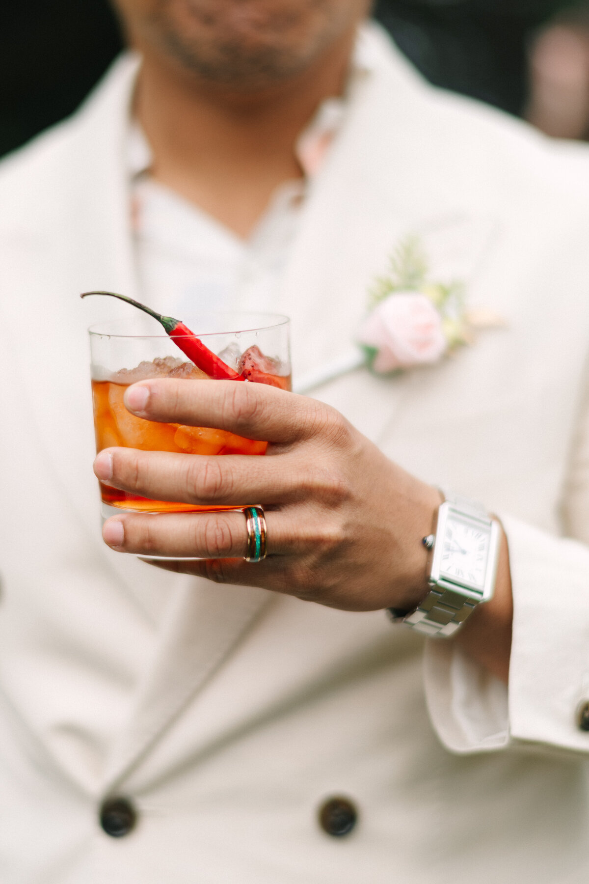 groom holding his signature drink