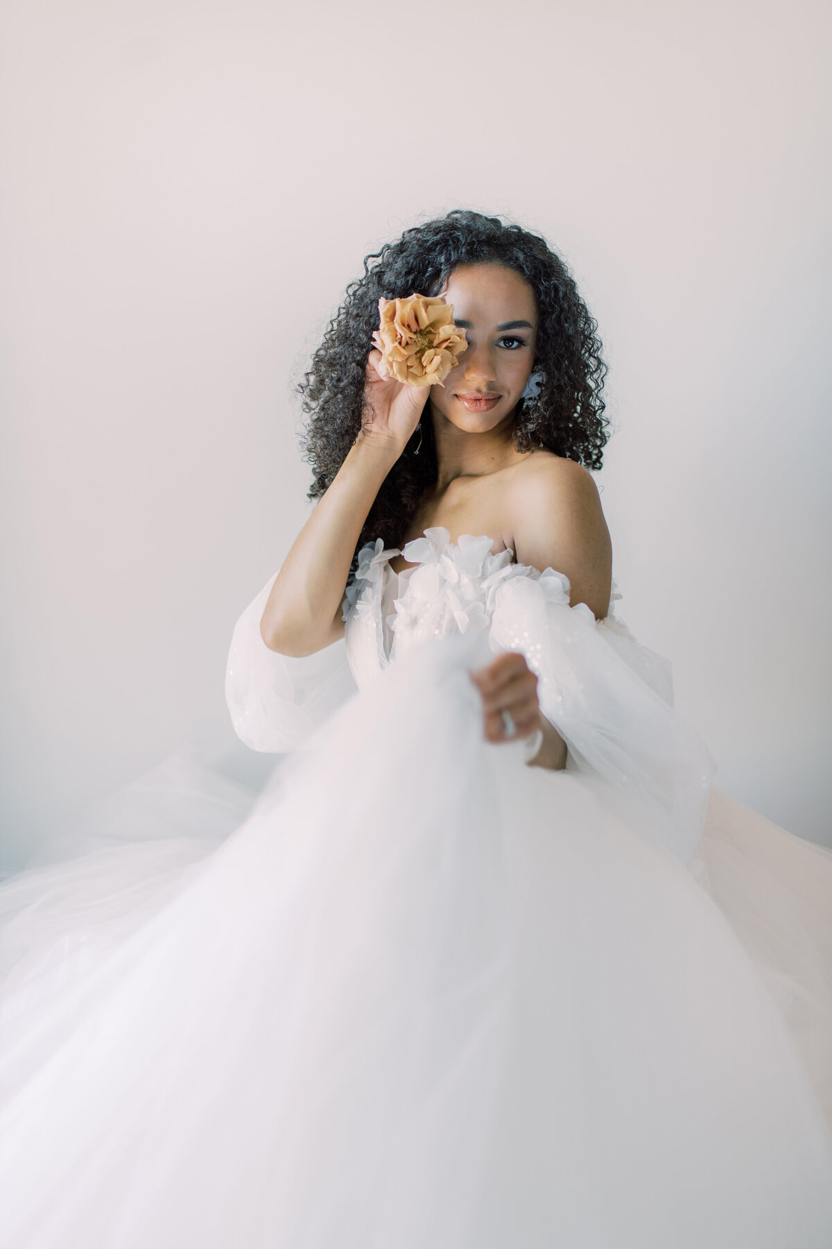 A stunning bridal portrait of a bride with voluminous curls and a captivating gaze, captured by Christine Grace Photography in Toronto.