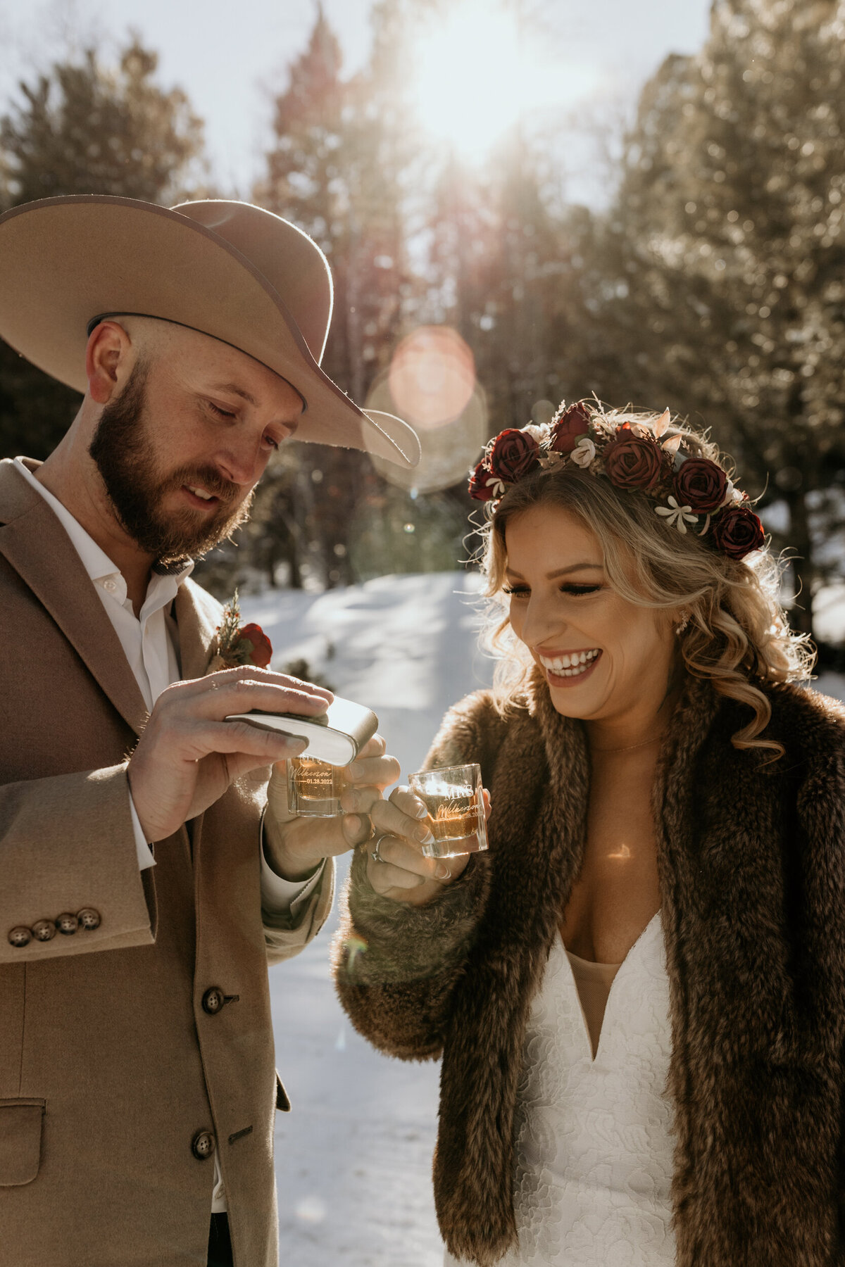 bride and groom pouring whiskey in custom shot glasses