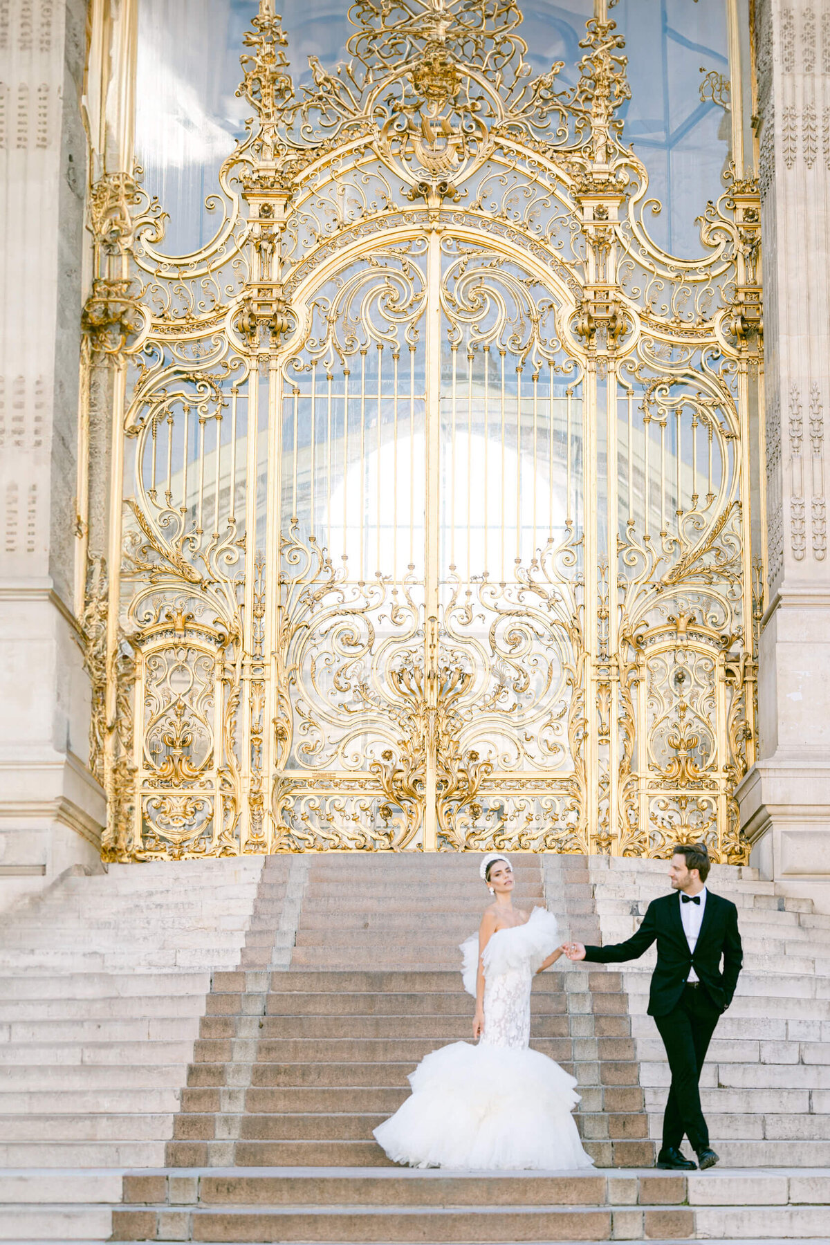 A wedding photo of a bride in her white dress in the streets of Paris in France.