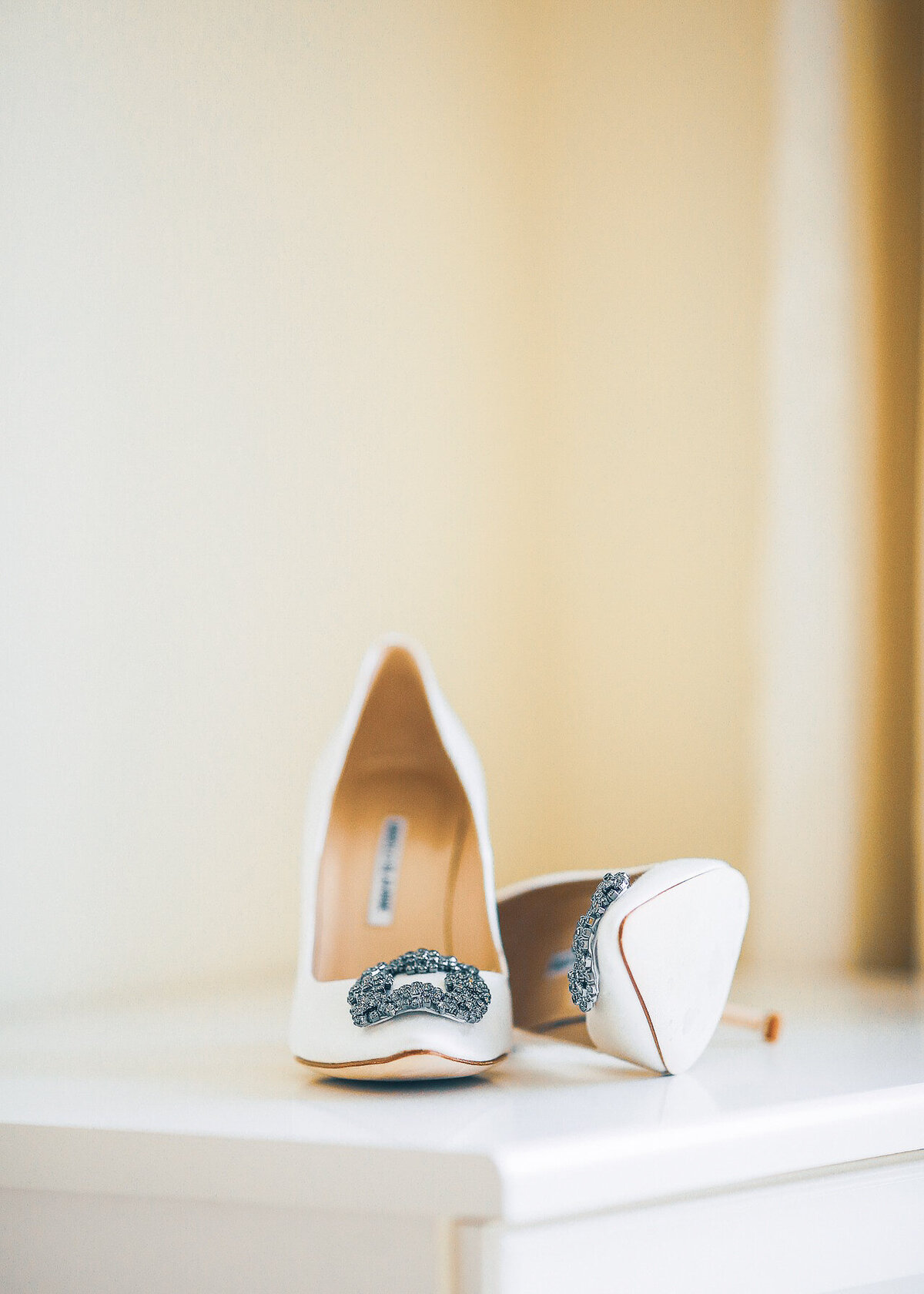 A pair of Jimmy Choo wedding shoes are photographed on a luxury wedding day.