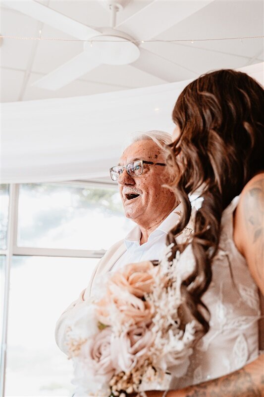 "Experience heartwarming moments captured in our gallery as Tamara and her father share a joyful stroll down the aisle, radiating smiles and creating cherished memories. Explore our collection for more unforgettable wedding moments captured with love and expertise."