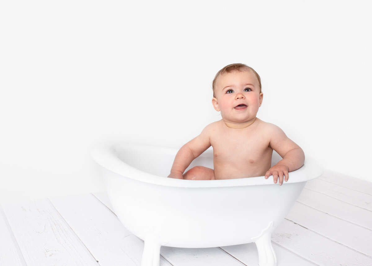 Baby in a clawfoot bath during a milk bath photoshoot by Lauren Vanier Photography in Hobart Tasmania