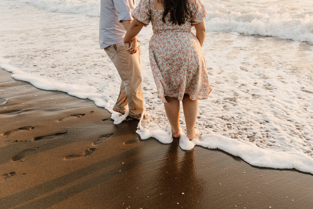 couple plays in ocean waves san francisco