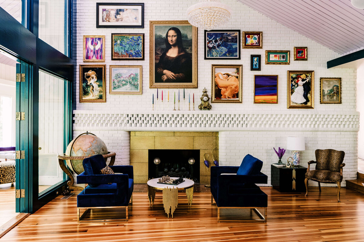 sweet southern home merry maximalism gold fireplace blue velvet chairs and artwork