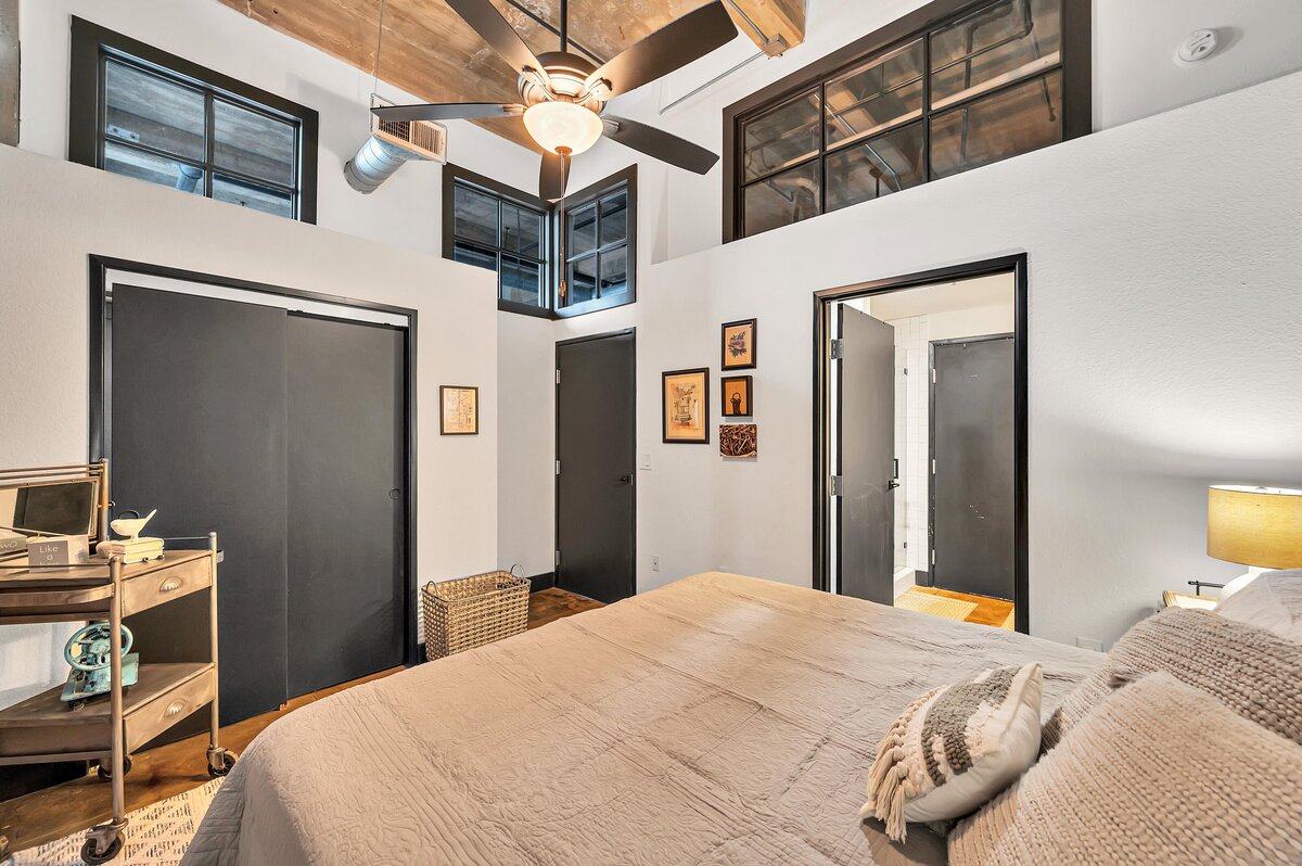 Beautiful bedroom in this three-bedroom, two-bathroom industrial vacation rental loft with free WiFi, skyline view, and fully stocked kitchen in downtown Waco, Tx
