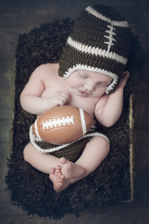 Newborn baby in football outfit in Kennebunk Maine