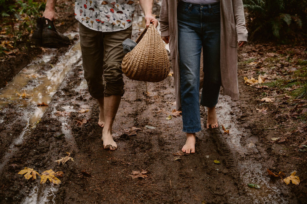 couple walking barefoot  on muddy trail in port alberni